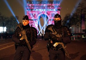 Policemen secure the Champs Elysees Avenue as Revellers gather during New Year celebrations in Paris,France, late December 31, 2016. REUTERS/Jacky Naegelen